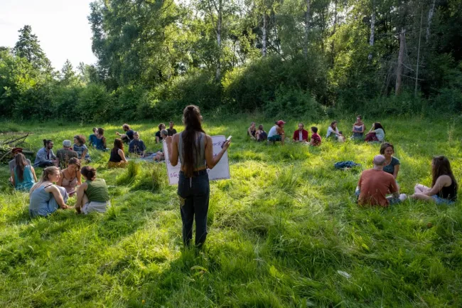 Junge Menschen sitzen im Kreis und sprechen über die Transformation in Hessen